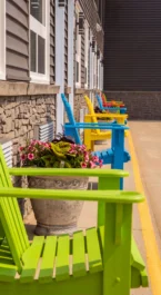 Colourful chairs line a patio outside Crossroads Inn & Suites.