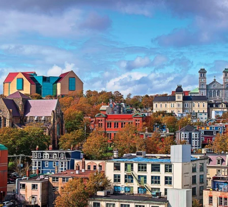Charming cityscape view near Crossroads Inn & Suites, with vibrant buildings and rolling hills.